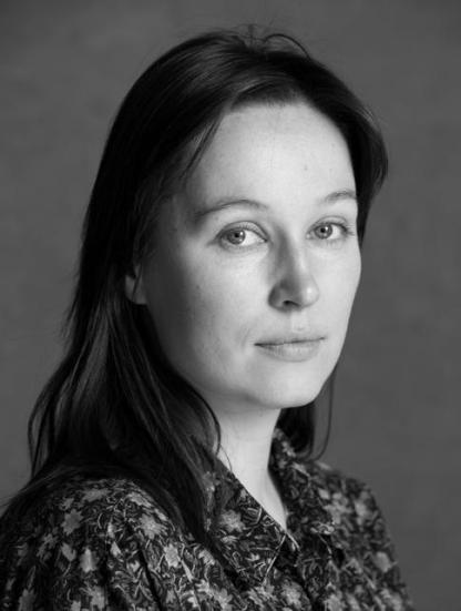 A black and white head shot of Sara Gurevitsch, who has a dark long hair.