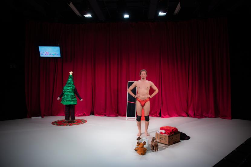 Photo: Haliz Yosef Two persons dressed in Santa Claus costumes are leaning on each other.