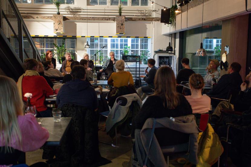 People listening to a panel discussion